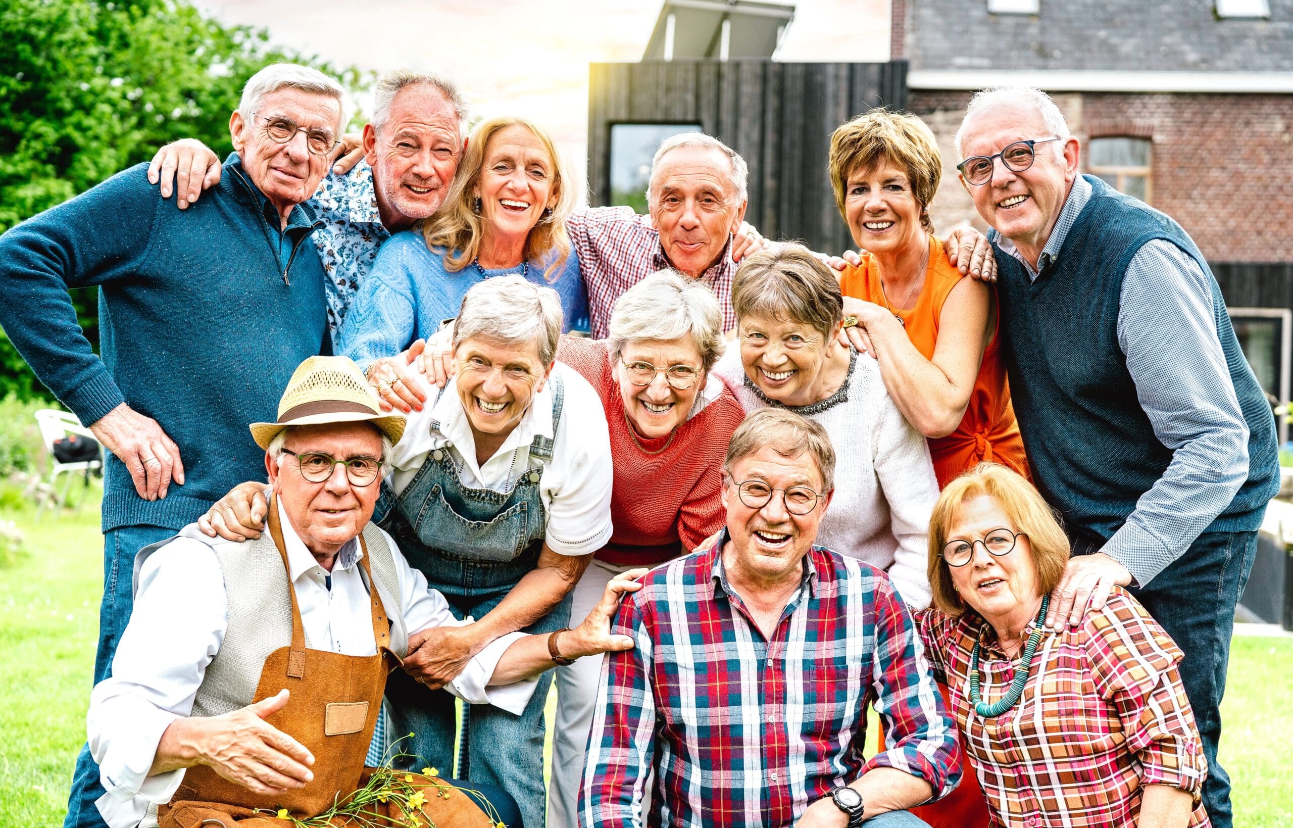 A smiling group of elderly people in the sunshine