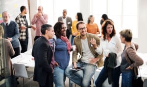 A group laugh together whilst sat in an office