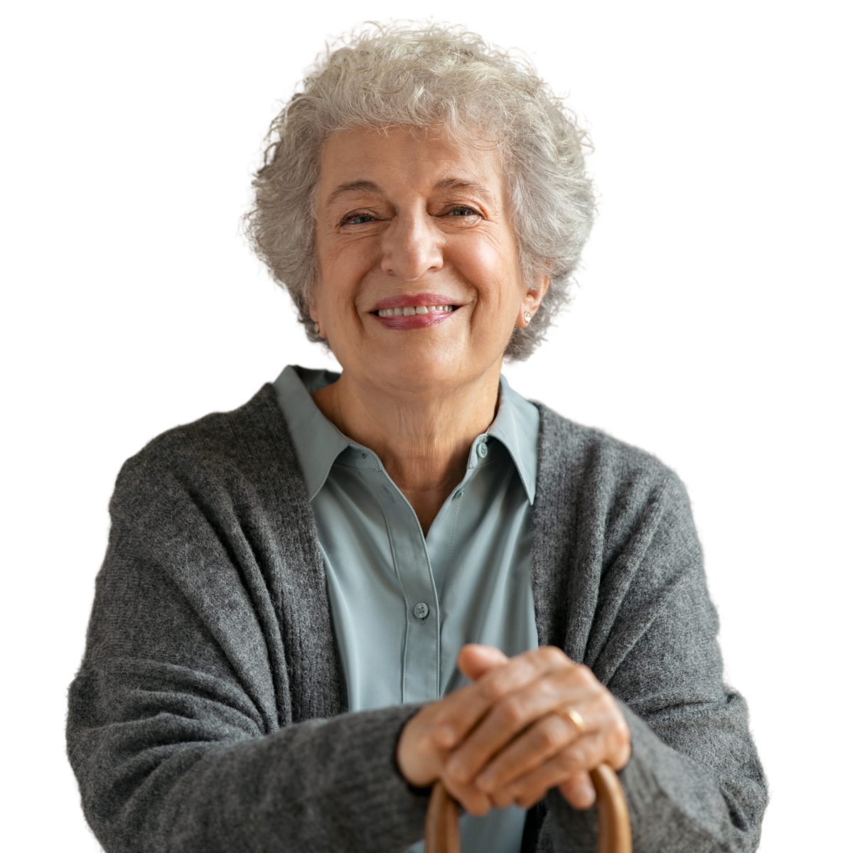 An older woman with a cane smiles for the camera